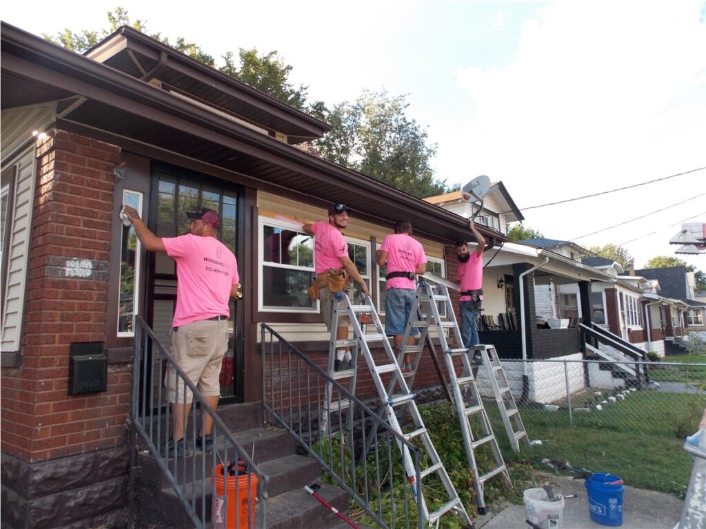 Windows Plus technicians working on a building exterior