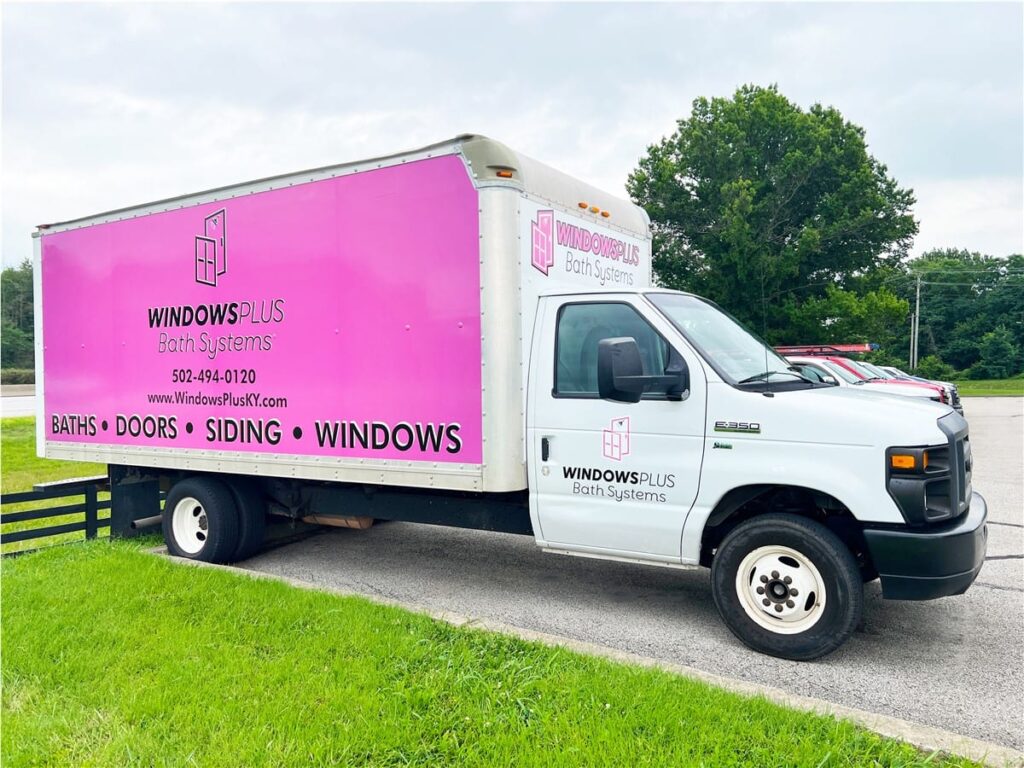 Windows Plus large white truck with pink branded banner on side